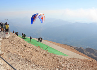  group of paragliders take off from high mountain Tahtali