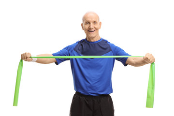 Elderly man in sportswear stretching a rubber band