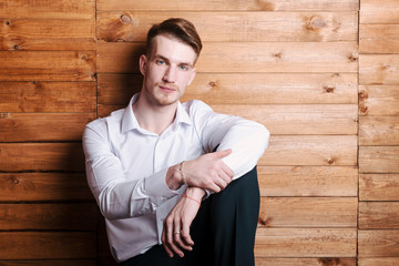 Young guy in a white shirt poses for the camera