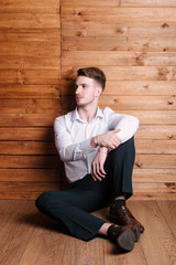 Young guy in a white shirt poses for the camera