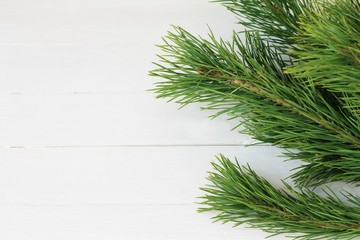 Christmas wooden background with natural decoration, fir tree and cones. Rustic wooden background, view from above. Flat lay, top view.