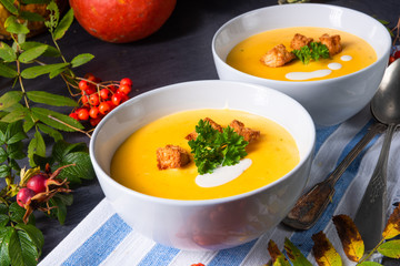 Delicious pumpkin soup with croutons and coconut milk