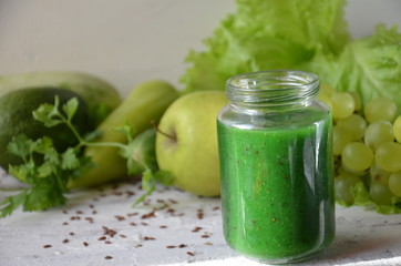 Detox diet. Green smoothie with different vegetables on white wooden background copy space. diet...