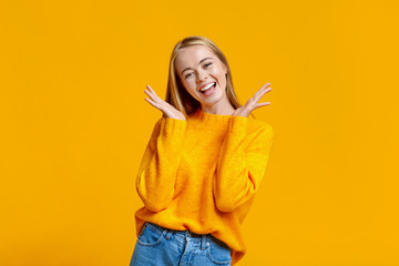 Portrait of young carefree girl on orange background
