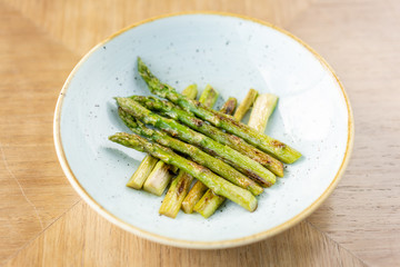 Fried asparagus. Various side dishes in the restaurant menu