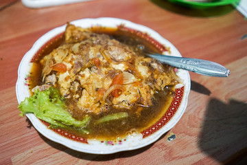 Lamb tongue steak with scrambled egg with vegetable and sauce. Unique food in Solo Indonesia