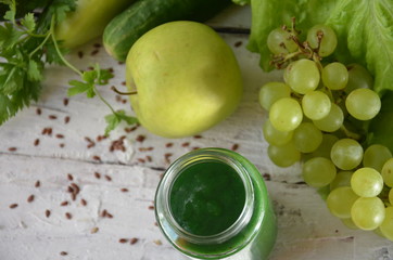 Detox diet. Green smoothie with different vegetables on white wooden background copy space. diet vegitarians healthy low calorie food. salad, greens, green apple chia or flax linen seeds