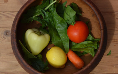 Vegetables in wooden bowl. Healthy food. Top view.