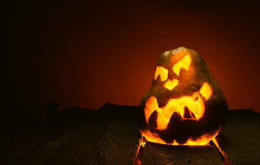 Scary Halloween pumpkins on wood in a spooky place at night. Poster concept.