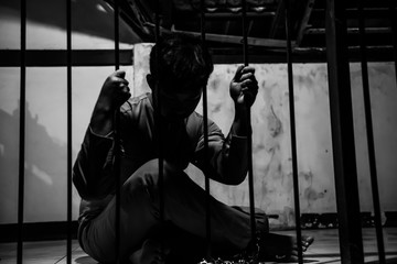 Asian man desperate at the iron prison,prisoner concept,thailand people,Hope to be free,Serious...