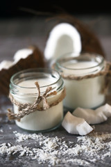 Keto diet. Keto drinks. Jars of coconut milk, coconut flakes, coconut. Coconut milk extraction. Vegan milk. Selective focus. Macro.