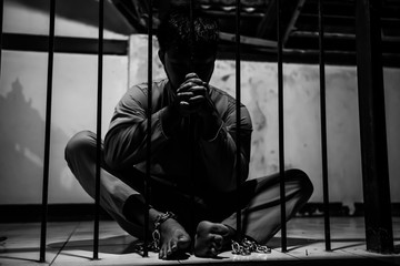 Asian man desperate at the iron prison,prisoner concept,thailand people,Hope to be free,Serious...