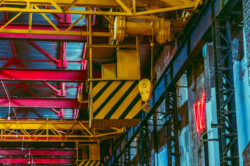 The interior of a big industrial building or factory with steel constructions