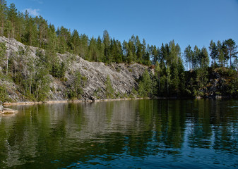 Water landscape of a mountain park.The picturesque landscape of the mountain natural park Ruskeala. Visible are rocks, a lake, coniferous forest, mountains, wildlife. Russia, Karelia