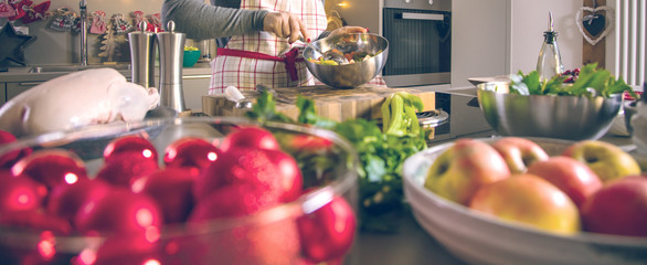 Young Woman Cooking in the kitchen. Healthy Food for Christmas (stuffed duck or Goose)