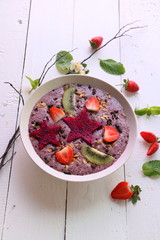 Fresh Smoothie in bowl with fresh fruit topping