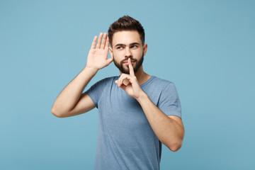 Young man in casual clothes posing isolated on blue wall background, studio portrait. People...
