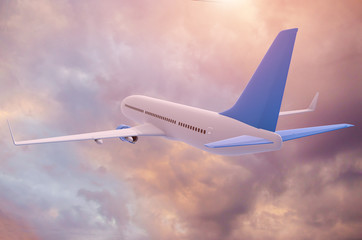 The plane flies on a background of sunset clouds