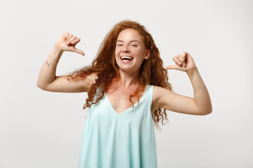 Fototapeta na wymiar Young smiling redhead woman in casual light clothes posing isolated on white wall background studio portrait. People sincere emotions lifestyle concept. Mock up copy space. Pointing thumbs on herself.