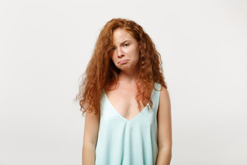 Young displeased offended redhead woman in casual light clothes posing isolated on white...
