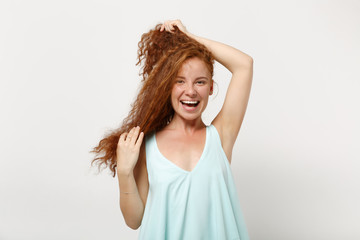 Young laughing cheerful redhead woman girl in casual light clothes posing isolated on white wall background, studio portrait. People lifestyle concept. Mock up copy space. Having fun, holding hair.