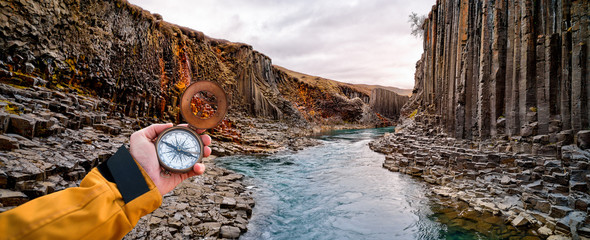 Beautiful landscape with old compass on traveler's hand. Traveling concept. © Lukas Gojda