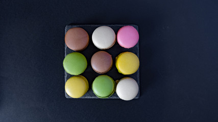 macarons seen from above on a black background