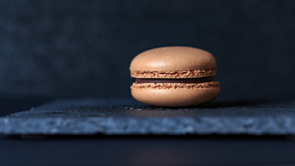 macaron on slate plate on a black background