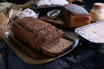 Pumpernickel bread with seeds on rustic table