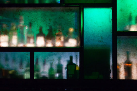 bar counter with bottles out of focus