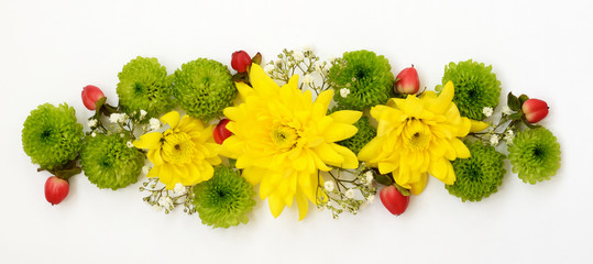 Yellow and green flowers with red berries in a floral decoration