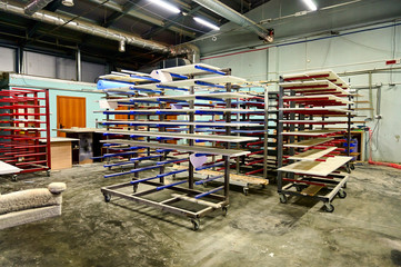Photo workshop for painting and assembling furniture. Parts and tools for manufacturing and painting parts are depicted.