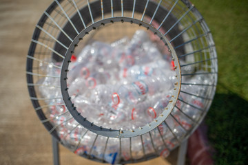 plastic bottles are collected in a metal basket