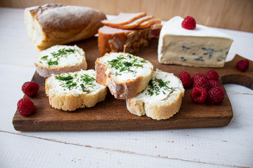 Slices of cheese, medium hard cheese, homemade or Swiss cheese and hard cheese on a wooden surface.