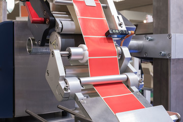 Fragment of the conveyor of the pharmaceutical labeling machine. Abstract industrial background.