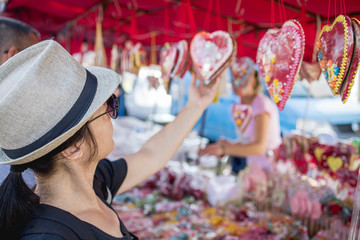 An adult woman looks at the goods at the market
