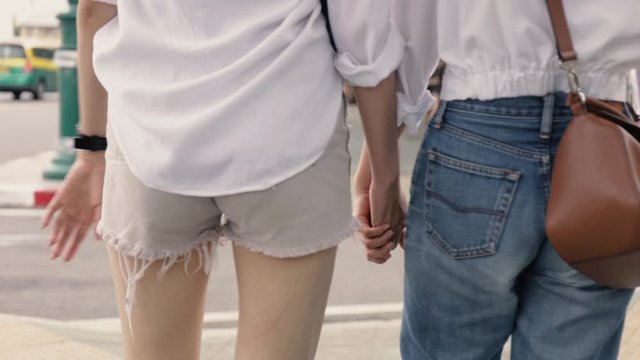 Happy Asian lesbian couples holding hands enjoying traveling in Thailand. Beautiful young women having fun in vacation time. LGBT concept. Close up shot.