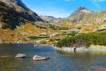 Travel background of autumn Skokom lake above the Skok waterfall near to Strbske Pleso in Slovakia © andras_csontos