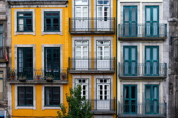 The facade of traditional building with beautiful windows at the Baixa neighborhood in the city of Porto, Portugal
