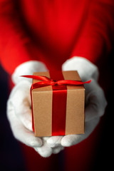 Woman's hands with white gloves with gift boxes