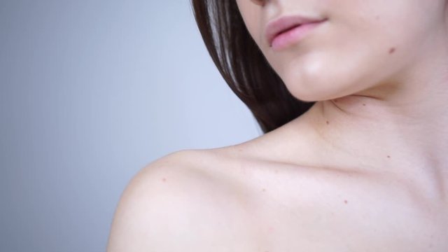 The girl takes off the bra strap. Bare shoulder.