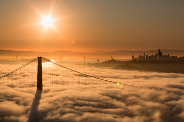 Aerial view of Golden Gate Bridge with Low Fog at Sunrise