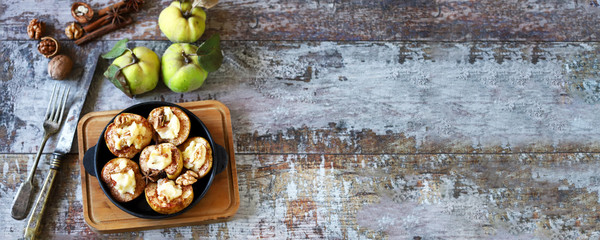 Baked quince with cheese and cinnamon in a pan. Healthy snack or dessert. Selective focus. Macro.