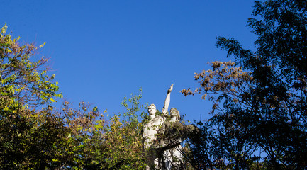  An abandoned Soviet sculpture of a worker and a peasant woman in an old park.