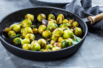 Frying pan with roasted brussel sprouts on table