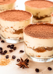 Tiramisu in the glass decorated whith mint on the wooden background