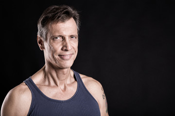 40-50 years old fit man with a vest looking at the camera