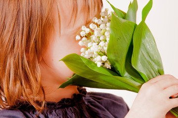 portrait of cute caucasian child girl sniffing beautiful flower