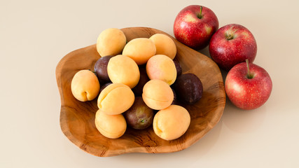 Farm organic plums, yellow apricots and apples