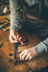 Luthier repair violin in his workshop - 296172698